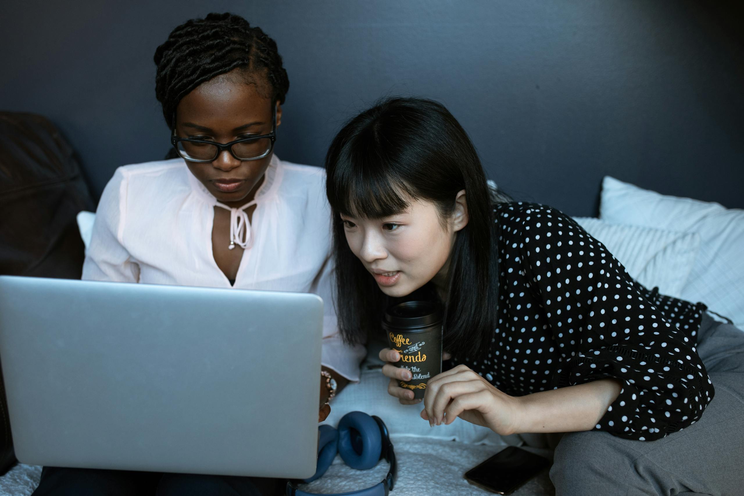 Two women studying for the NBHWC exam